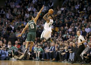 Boston Celtics guard Isaiah Thomas (4) shoots a three-point shot against the defense of Milwaukee Bucks guard Malcolm Brogdon (13) during the second half of an NBA basketball game, Wednesday, March 29, 2017, in Boston. (AP Photo/Mary Schwalm)