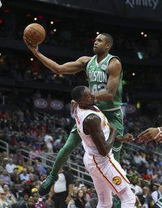 Boston Celtics forward Al Horford (42) drives against Atlanta Hawks center Dewayne Dedmon (14) during the first half of an NBA basketball game Monday, Nov. 6, 2017, in Atlanta. (AP Photo/John Bazemore)