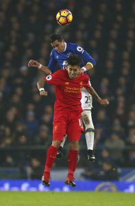 Liverpool's Roberto Firmino, front, challenges for the ball with Everton's Ramiro Funes Mori during the English Premier League soccer match between Everton and Liverpool at Goodison Park stadium in Liverpool, England, Monday, Dec. 19, 2016. (AP Photo/Dave Thompson)